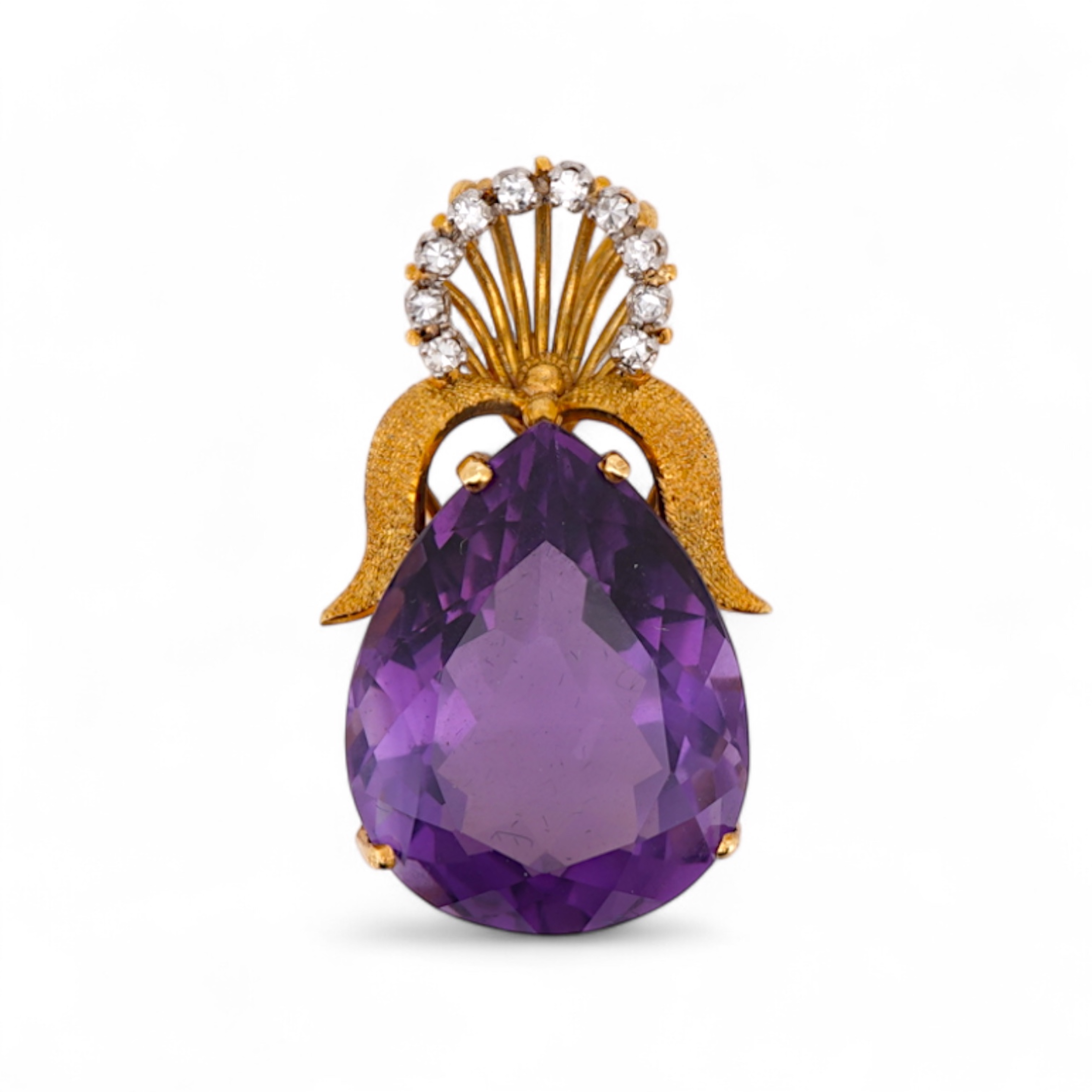 An Amethyst and diamond pendant, claw-set with a pear-shaped amethyst, topped with a foliate surmount in textured gold, accented with and arc of brilliant-cut diamonds totalling approximately 0.30 carats, length 3.5cm, s